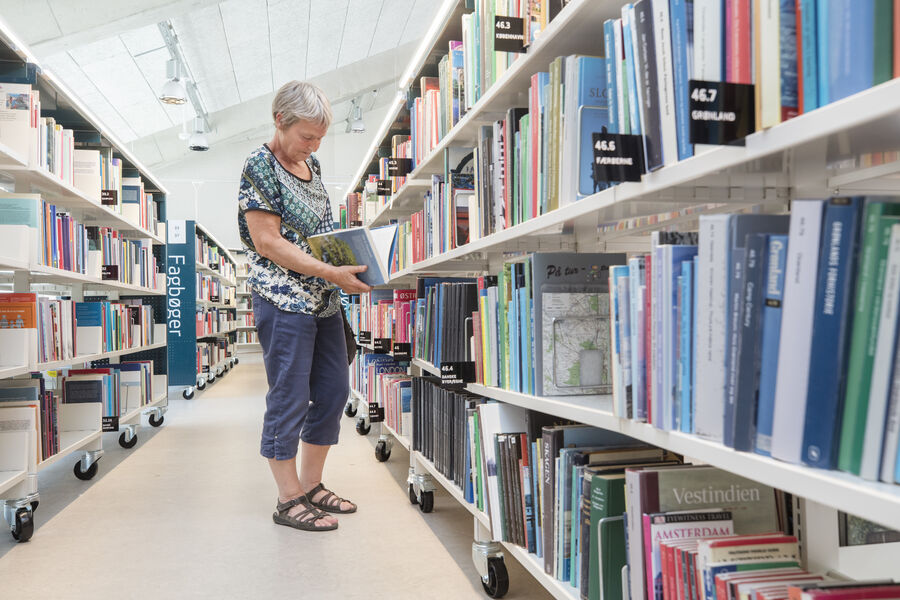 kvinde kigger på bøger på Slagelse Bibliotek